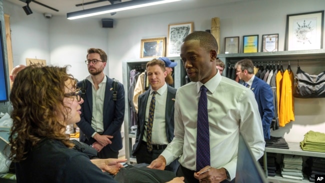 United States Deputy Treasury Secretary Wally Adeyemo buys a jacket at the Riotdevision store during his official visit to Kyiv, Ukraine, on May 29, 2024.