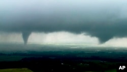 This image made from video provided by KWTV-KOTV shows two funnel clouds formed in Crescent, Okla., May 20, 2019. 