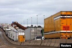 Trucks wait in a long queue at border customs control to cross into the U.S. at the Otay border crossing in Tijuana, Mexico, April 3, 2019.