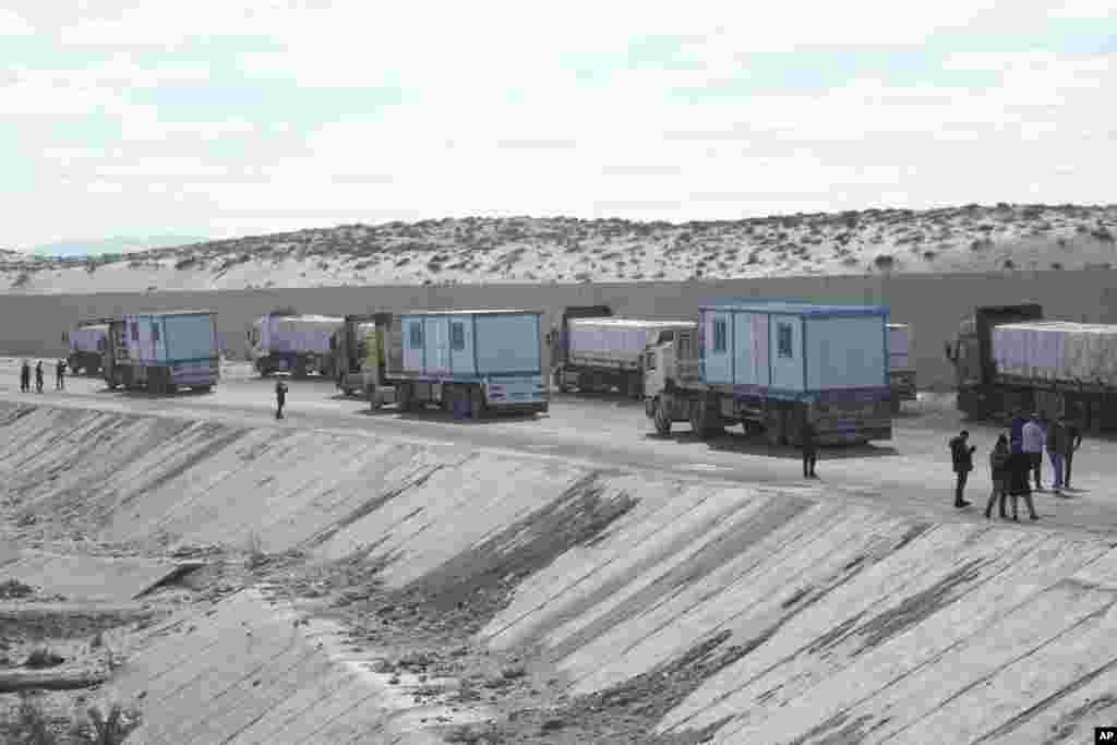 Truck drivers, transporting humanitarian aids, wait at the Baloza check point, on their way to cross the Rafah border crossing between Egypt and the Gaza Strip, Jan. 19, 2025.