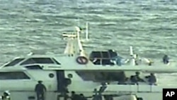 In this video image released by the Israeli Defense Ministry on November 4, 2011, Israeli soldiers on several small military boats appear to board a civilian boat believed to be one of two protest boats trying to violate Israel's blockade of the Gaza Stri