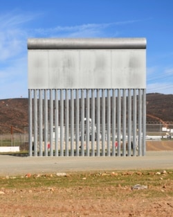 FILE - A border wall prototype stands in San Diego near the Mexico-U.S. border, seen from Tijuana, Mexico, Dec. 22, 2018.