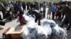 North Koran defectors carry plastic bags of leaflets condemning Pyongyang’s government policies. Leaflets attached to balloons get sent from the border town of Paju, South Korea, on Oct. 10, 2014.