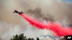 The Global Supertanker drops retardant while battling the Glass Fire in Napa County, Calif., on Sunday, Sept. 27, 2020.