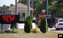 Vehicles are stopped by security personal as they enter a gate to Camp Edwards, Massachusetts, on Cape Cod, Sept. 22, 2014.