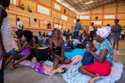 FILE - Internally displaced people sit inside a shelter at the Center Sportif of Carrefour in Port-au-Prince, Haiti, June 8, 2021, in this handout released June 15, 2021, by UNHaiti.
