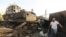 FILE - Workers inspect damage at the site of an air strike on the maintenance hub at the Hodeida port, Yemen, May 27, 2018. 