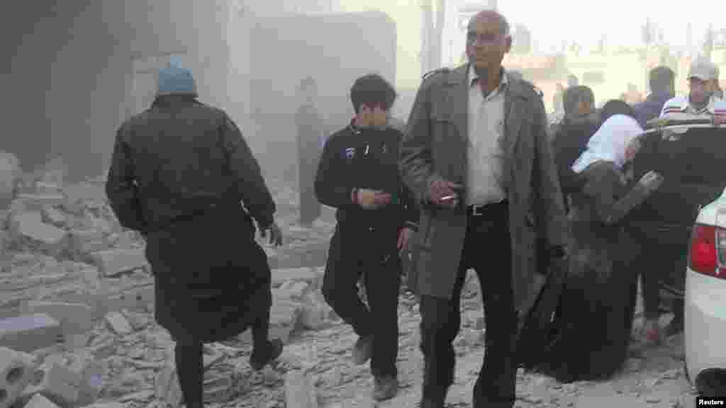 Residents inspect damage after what activists said was shelling from forces loyal to President Bashar al-Assad in Al-Atareb, Aleppo countryside, Syria, Feb. 16, 2014.&nbsp;