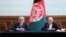 FILE - Afghan President Ashraf Ghani, right, and political rival Abdullah Abdullah, speak after they signed a power-sharing agreement at the presidential palace in Kabul, Afghanistan, May 17, 2020.