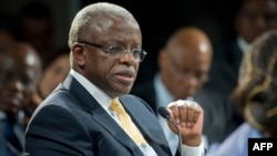 FILE - Uganda's then-Prime Minister Amama Mbabazi gives a speech at the World Economic Forum Meeting on Africa, Cape Town, S. Africa, May 9, 2013. 
