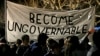 Protestors against a scheduled speaking appearance by polarizing Breitbart News editor Milo Yiannopoulos march on the University of California at Berkeley campus, Feb. 1, 2017, in Berkeley, Calif. 