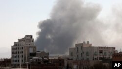 FILE - Smoke rises after Saudi-led coalition airstrikes on a target in Sanaa, Yemen, March 7, 2021. The coalition has launched a new air campaign on the war-torn country’s capital and on other provinces. 