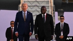 US President Joe Biden is welcomed by Angola Foreign Affairs Minister Tete Antonio on arrival at Quatro de Fevereiro Luanda International Airport in Luanda on Dec. 2, 2024.