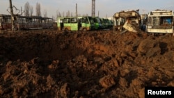 A crater is seen after a Russian missile strike at a compound of a public transport depot, amid Russia's attack on Ukraine, in Kharkiv, Ukraine Dec. 20, 2023.