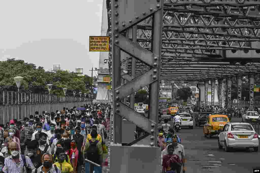 Commuters cross the Howrah Bridge as the state government suspends regular public transport during a lockdown imposed to curb the spread of the Covid-19 in Kolkata, India.