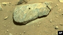 This Sept. 1, 2021 image provided by NASA shows the hole drilled by the Perseverance rover during its second sample-collection attempt in Mars' Jezero Crater. (NASA/JPL-Caltech via AP)