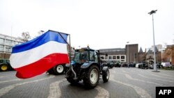 Farmers with their tractors arrive in front of the Provincial Government Office of Gelderland in Arnhem, Netherlands, on Dec. 18, 2019. 