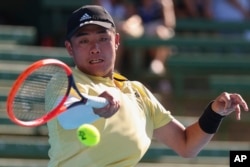 FILE - China's Wu Yibing plays a forehand return to Australia's Rinky Hijikata during their match at the Kooyong Classic in Melbourne, Australia, Jan. 11, 2023.