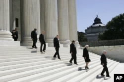 Associate justices walk down the steps of the Supreme Court as they wait for the casket carrying Chief Justice William H. Rehnquist to arrive, Sept. 7, 2005 in Washington.