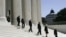 FILE - Justices walk down the steps of the Supreme Court building in Washington, Sept. 7, 2005.