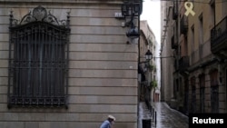 An elderly couple walks on a street, after Catalonia's regional authorities and the city council announced restrictions to contain the spread of the coronavirus disease (COVID-19) in Barcelona, Spain, July 17, 2020.