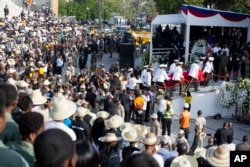 Police officers arrive with the coffin containing the remains of former President Rene Preval, at Champ de Mars plaza, in Port-au-Prince, Haiti, March 11, 2017.