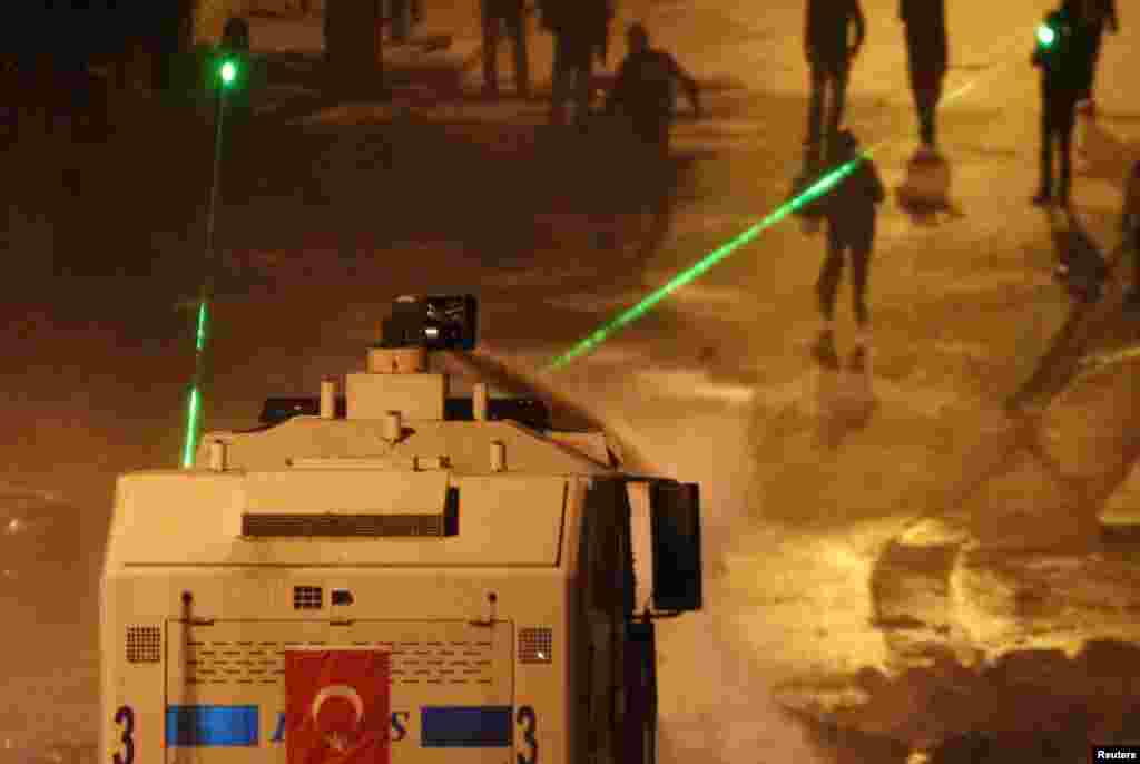 Riot police fire a water cannon at protesters during clashes on Kennedy Street in central Ankara, June 18, 2013. 