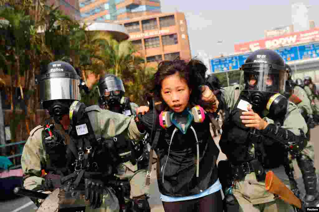 A protester is detained by riot police while attempting to leave the campus of Hong Kong Polytechnic University (PolyU) during clashes with police in Hong Kong, China November 18, 2019. 