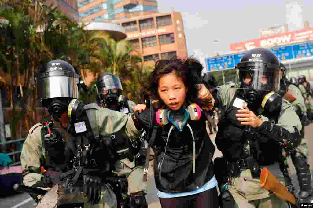 A protester is detained by riot police while attempting to leave the campus of Hong Kong Polytechnic University (PolyU) during clashes with police in Hong Kong, China November 18, 2019.
