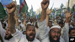 Supporters of the Pakistani religious party Jamaat-e-Islami chant slogans during a rally against drone strikes in the country's tribal areas in Karachi, Pakistan, June 5, 2011