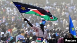 A man waves South Sudan's national flag as he attends the Independence Day celebrations in the capital Juba, July 9, 2011.