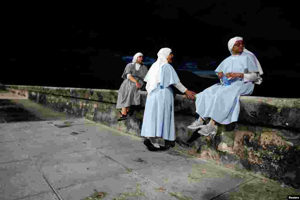 Nuns sit at the sea front in Havana, Cuba, July 10, 2019.