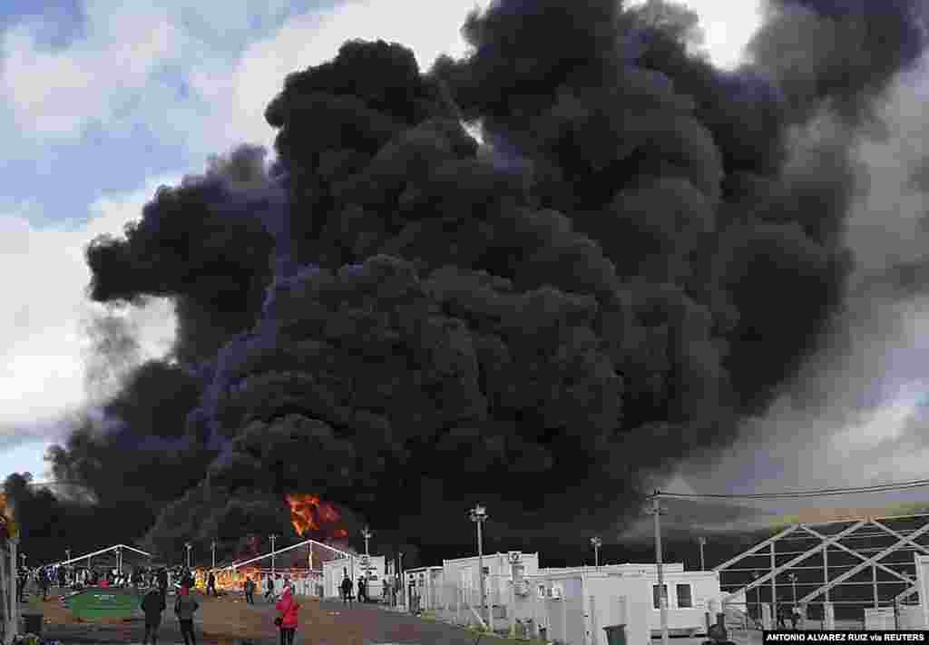 Smoke rises from a fire at a migrant camp Lipa, near Bihac in western Bosnia. The cause of the fire at the camp which houses some 1,200 migrants, was not immediately known.