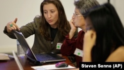 Brown University graduate Maia Weinstock, left, works with Anne Fausto-Sterling, of Cranston, R.I., center, a professor of biology and gender studies on the Brown campus in Providence, Rhode Island.