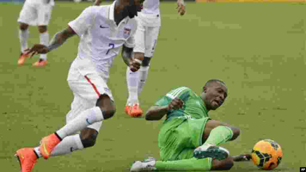 Nigeria's Shola Ameobi tries to clear the ball away from United States's DaMarcus Beasley.