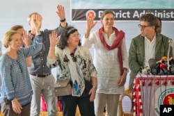 Members of the U.N. Security Council team visiting Bangladesh raise their hands during a press conference at the Kutupalong Rohingya refugee camp in Kutupalong, Bangladesh, April 29, 2018. The diplomats, were responding to a question from a journalist who asked how many of them believed that the people in the camps are Rohingyas.
