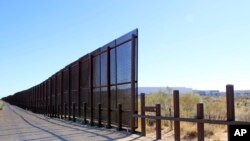 FILE: This Jan. 18, 2018 photo provided by U.S. Customs and Border Protection shows as existing wire mesh fence and a vehicle barrier near the Santa Teresa, N.M., port of entry.