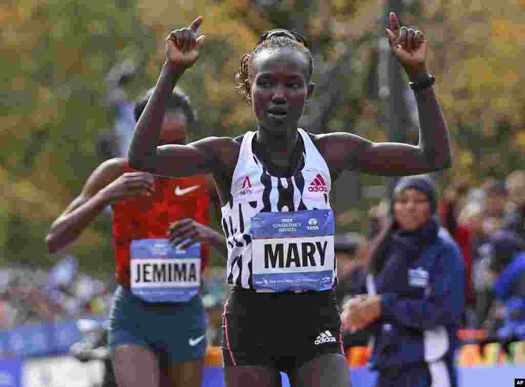 Mary Keitany celebrates as she edges out Jemima Sumgong, both of Kenya, after the pair finished first and second in the women's division of the 44th annual New York City Marathon in New York, Nov. 2, 2014.