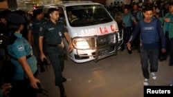 One of a convoy of three ambulances believed to carry the body of Bangladesh Jamaat-E-Islami leader Abdul Quader Mollah leave the central jail in Dhaka, Dec.12, 2013. 
