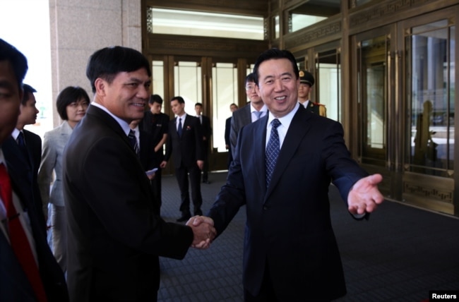 Meng Hongwei (R), Chinese vice public security minister, shakes hands with Nguyen Quang Dam, the commandant of the Vietnam Coast Guard, in Beijing, China, August 26, 2016.