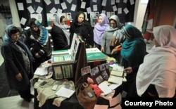 A group of women looking at the war victims mementos boxes during a workshop in Kabul Afghanistan. (Photo: Afghanistan Human Rights and Democracy Organization)