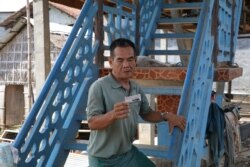 Paong Lat, 66, a villager in Tbong Khmum province, lives nearby the $57-million bridge project, funded by China. (Sun Narin/VOA Khmer)