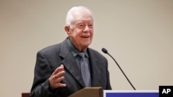 FILE - Former president Jimmy Carter speaks at a Baptist conference in Atlanta, Georgia, Sept. 15, 2016. On Wednesday, Carter unexpectedly defended President Donald Trump on immigration issues.