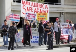 Police stand by as demonstrators who support President Donald Trump's executive orders barring entry to the U.S. by travelers from seven Muslim-majority countries rally at Los Angeles International Airport, Feb. 4, 2017.