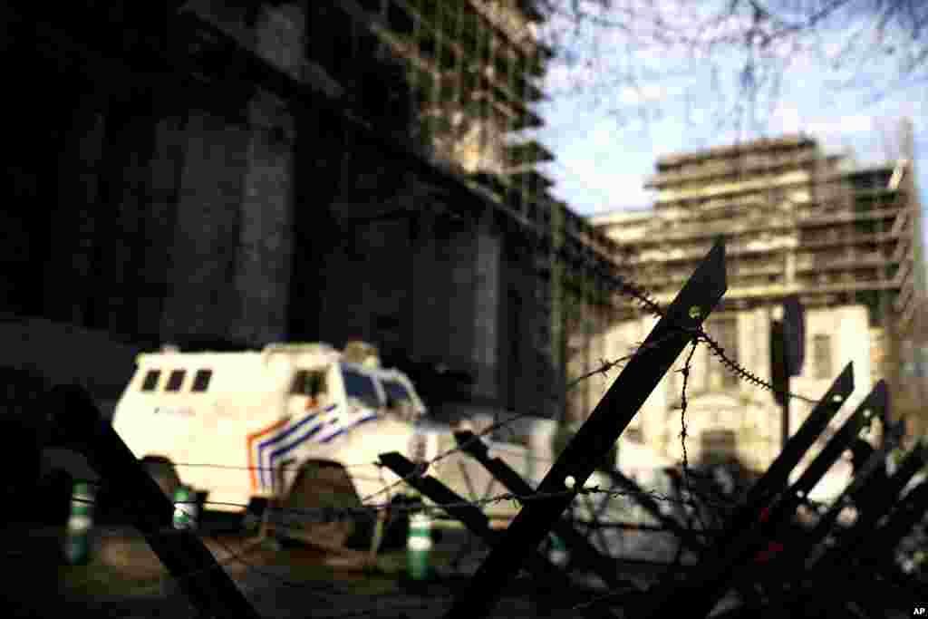 An armored police vehicle and barbed wire fence block the way outside the Justice Palace during the trial of Mehdi Nemmouche in Brussels, Belgium. Nemmouche is charged with &#39;terrorist murder&#39; over the killing of an Israeli couple and two workers at the Brussels Jewish Museum.