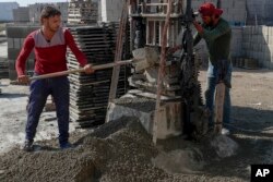 Palestinian workers make concrete bricks from recycled rubble. (AP Photo/Adel Hana)