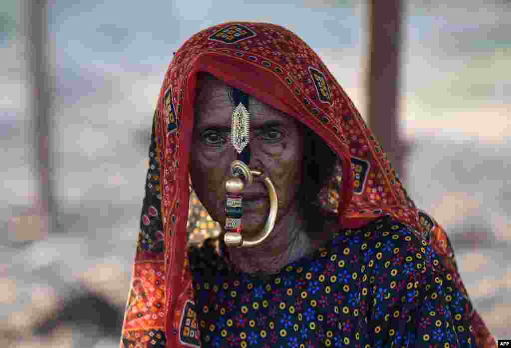 A member of a nomadic shephard community from the remote Kutch region of western Gujarat state, India, looks on at a camp where the group has relocated in search of sustenance for their livestock, in Mehsana district, about 100 kilomters from Ahmedabad.