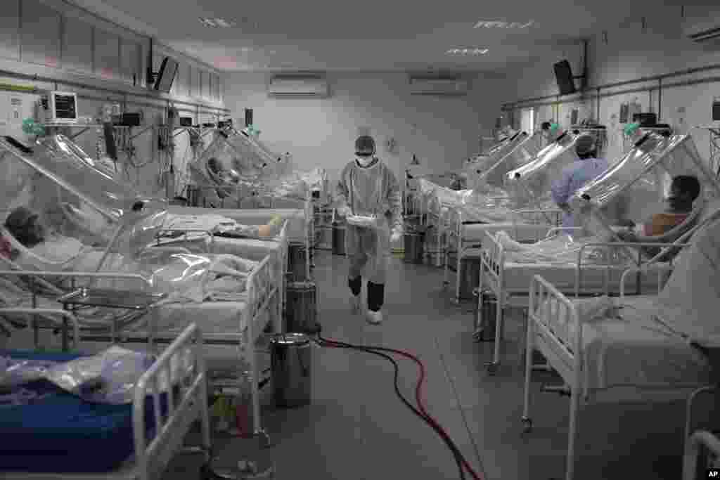 COVID-19 patients are treated inside a non-invasive ventilation system named the 'Vanessa Capsule' at the municipal field hospital Gilberto Novaes in Manaus, Brazil, May 18, 2020.