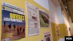 Reports in newspapers describe Europe's current migrant crisis. (L. Bryant/VOA)
