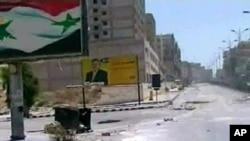 Image released by the Syrian official news agency SANA, empty streets with debris are shown of what SANA describes as the Syrian army restoring "security and stability" to the central city of Hama, August 4, 2011